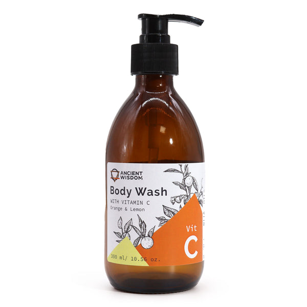 Aromatherapy Body Wash with Vitamin C in a clear pump bottle. The liquid soap has a vibrant orange colour, reflecting its citrus ingredients. The elegant bottle design showcases the product's premium quality.