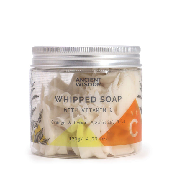 Aromatherapy Whipped Soap with Vitamin C in a clear jar. The soap has a light, fluffy texture and a pale yellow colour. The transparent container showcases the whipped consistency of the product.