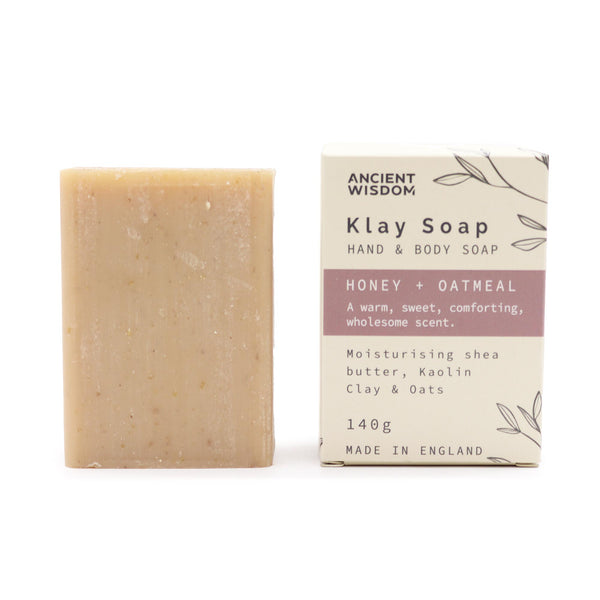 Klay Soap - Honey Oatmeal. A rectangular bar of natural, light-coloured soap with visible oatmeal flakes for gentle exfoliation. The soap is infused with Kaolin clay for oil control and has a comforting honey and oatmeal scent.