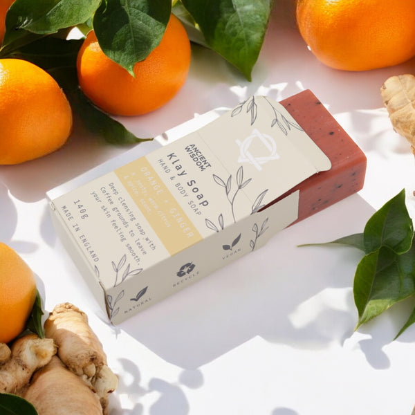 Klay Soap - Orange & Ginger. A rectangular bar of natural, dark-coloured soap with visible cranberry seeds for exfoliation. The soap is infused with Fuller's earth clay and activated charcoal for detoxifying properties.