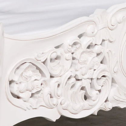 Ornate white plaster molding highlights the Elegant Off-White Rococo King Bed in Mahogany Wood