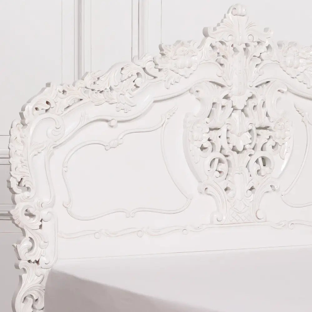 Ornate white headboard with floral carvings on Elegant Off-White Rococo King Bed