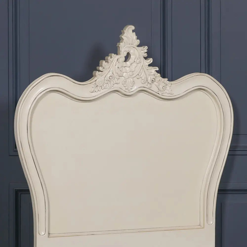 Ornate white headboard with intricate carvings on a stylish 3ft single bed