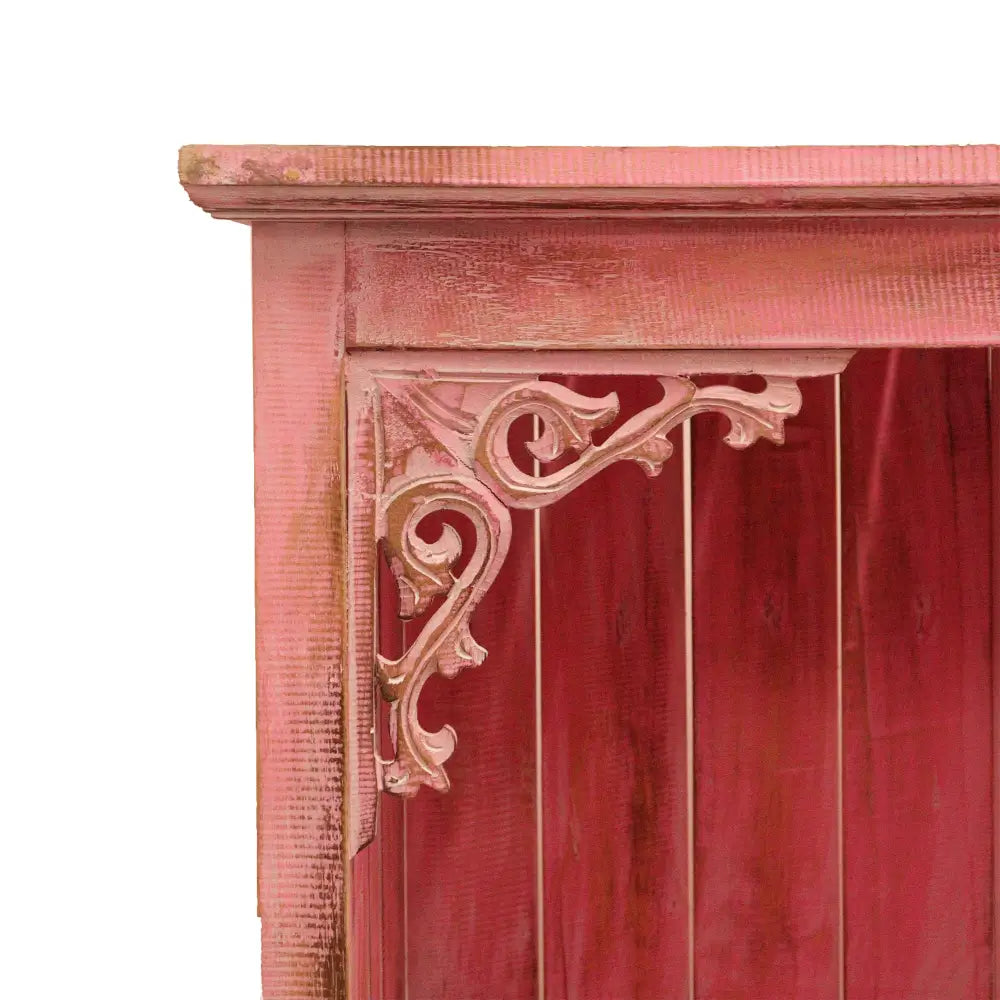 Ornate corner bracket on pink Albasia wood bathroom cabinets with exceptional attention