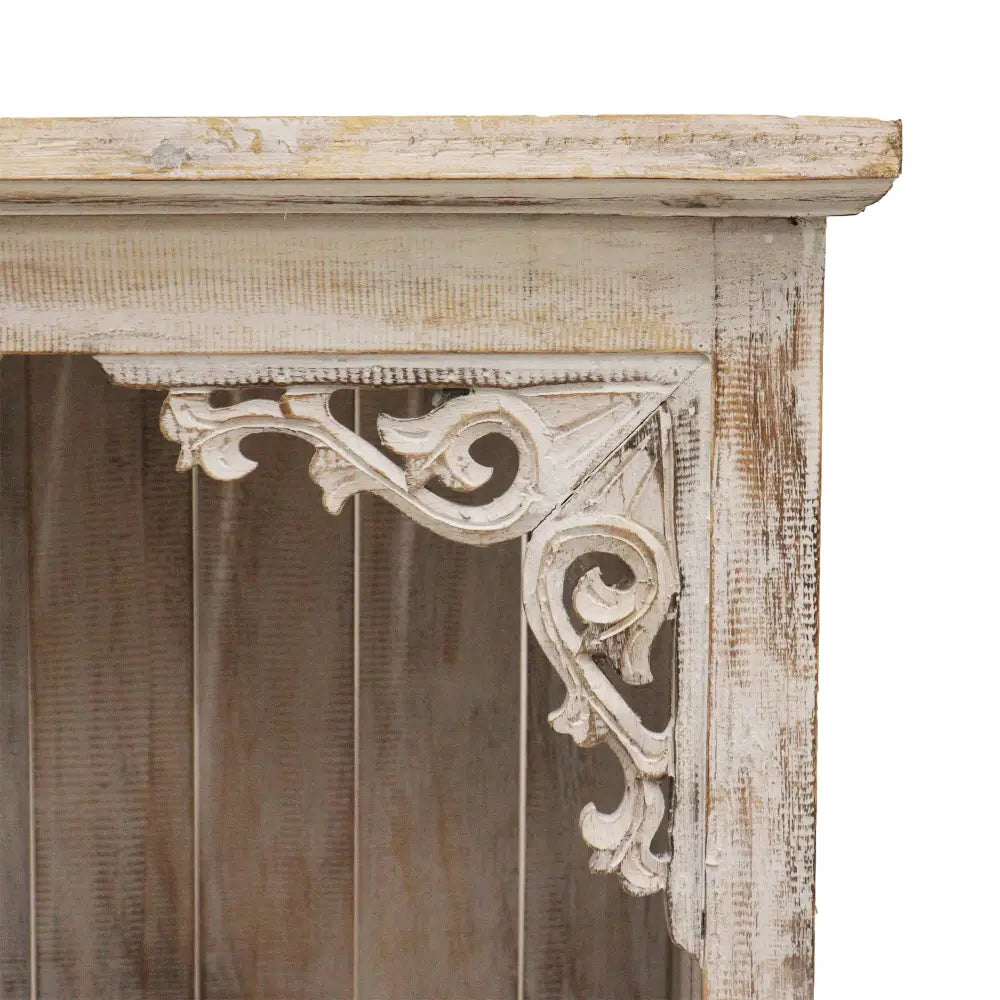 Distressed Albasia wood bathroom cabinet featuring ornate white scrollwork details