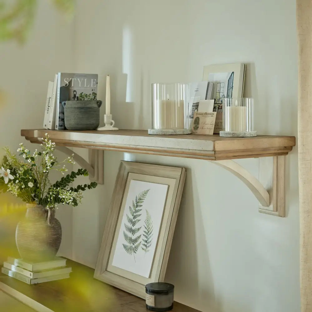 Wooden wall shelf showcasing the Athena Stone Large Hurricane Lantern with decor