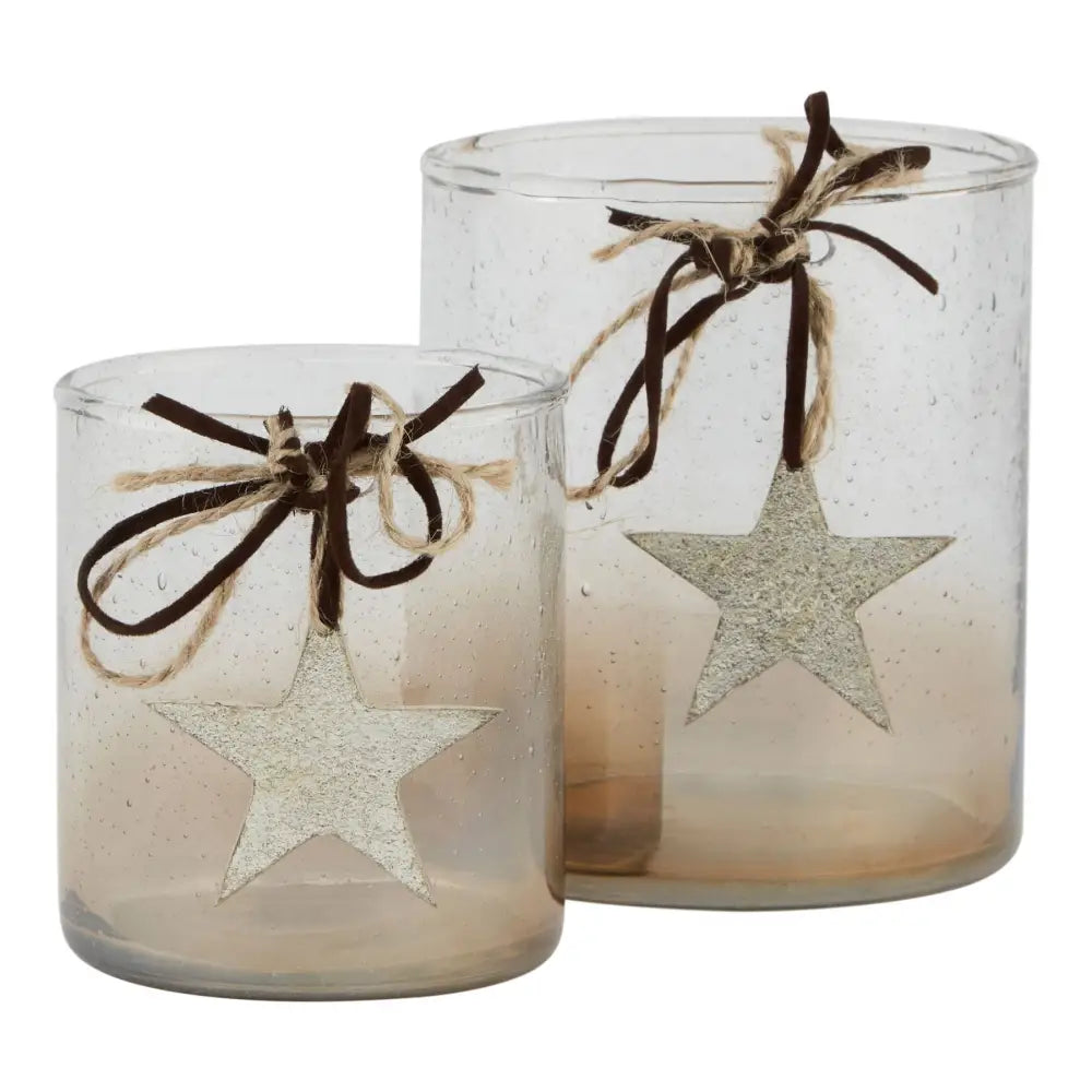 Two silver star-decorated candle holders with ribbon bows from Coffee Ombre Collection