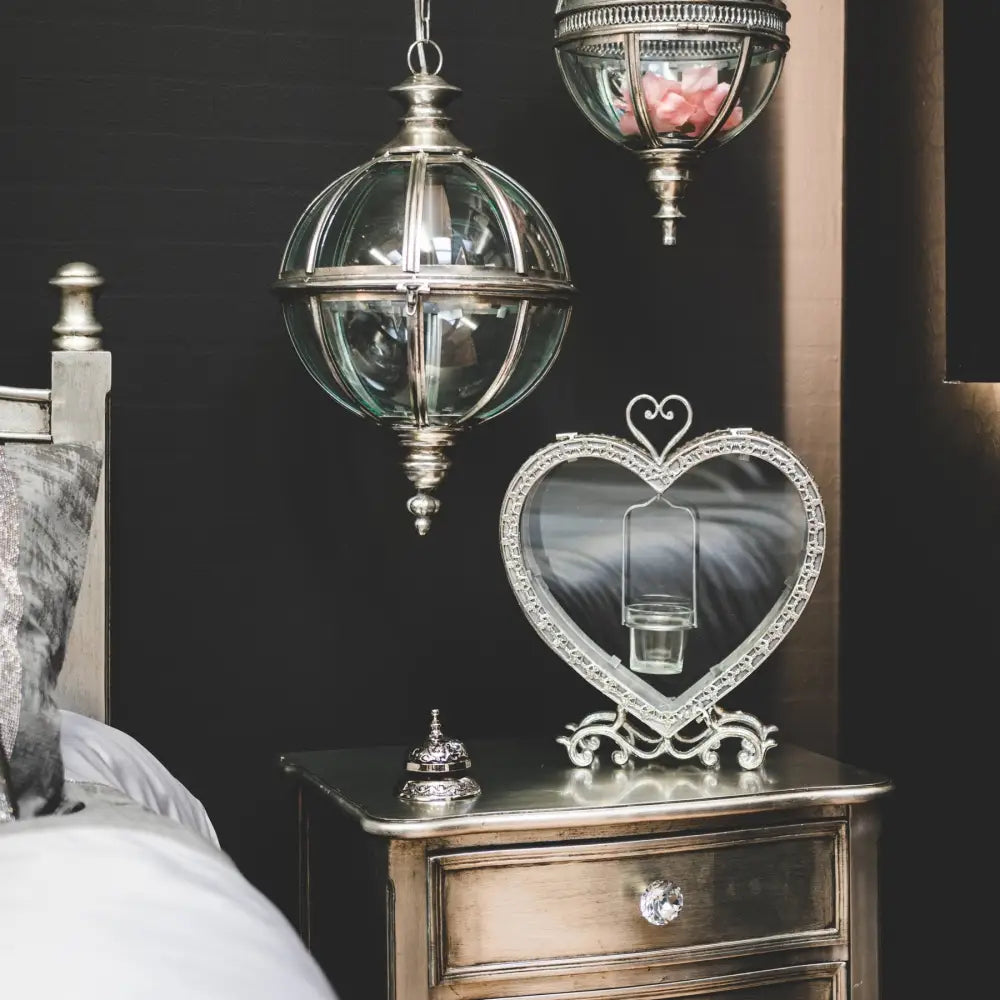 Ornate glass and metal pendant light highlighting the Antique Silver Heart Tealight Lantern