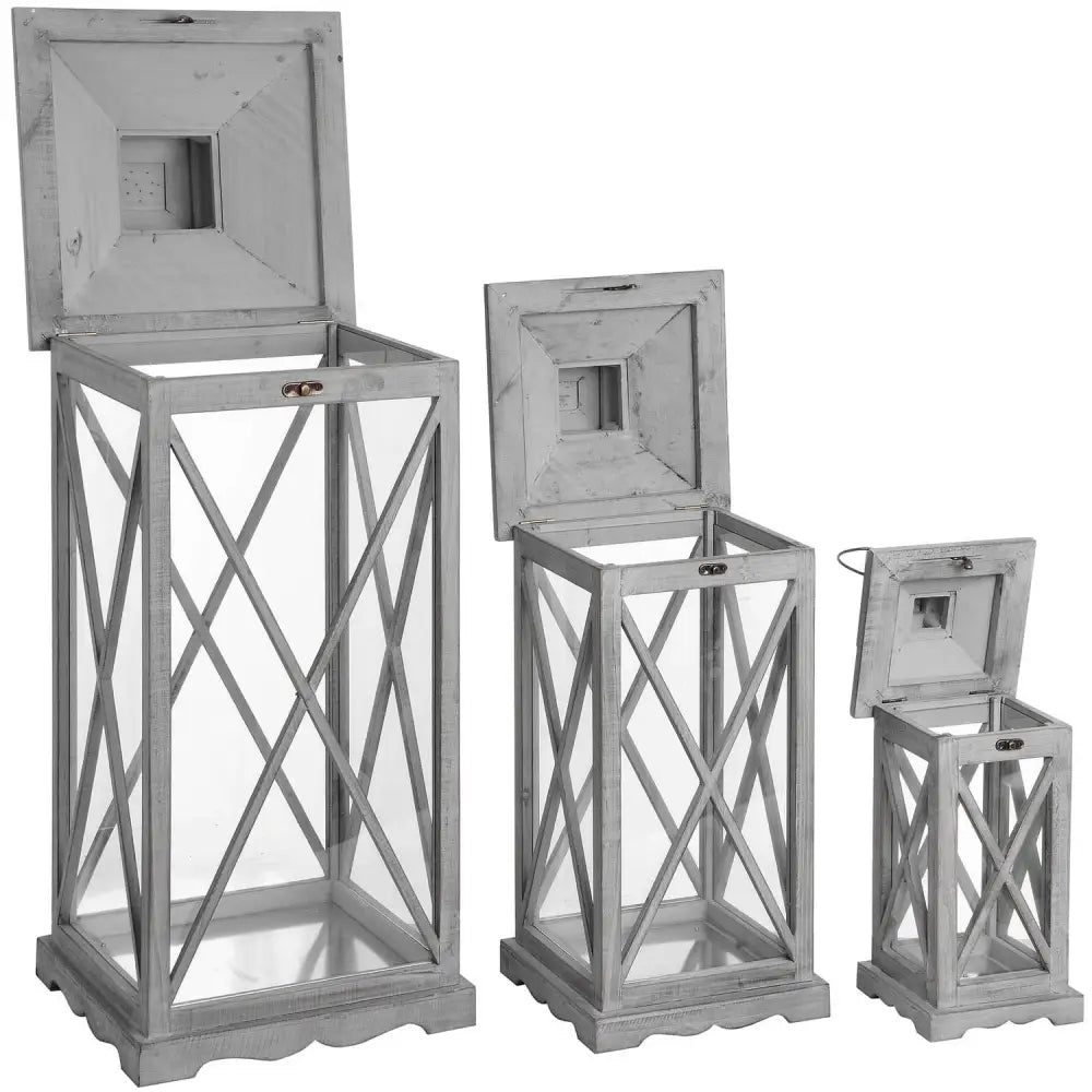 Set of three decorative wooden lanterns with cross-braced frames and glass panels