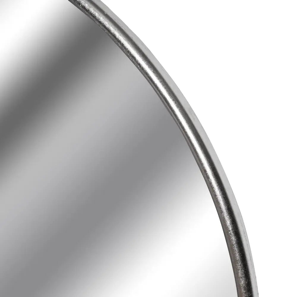 Curved edge of a Large Circular Metal Wall Mirror with Silver Foil Finish