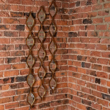 Decorative metal chain-link wall hanging for a chic home mirror with candle diffuser vibes