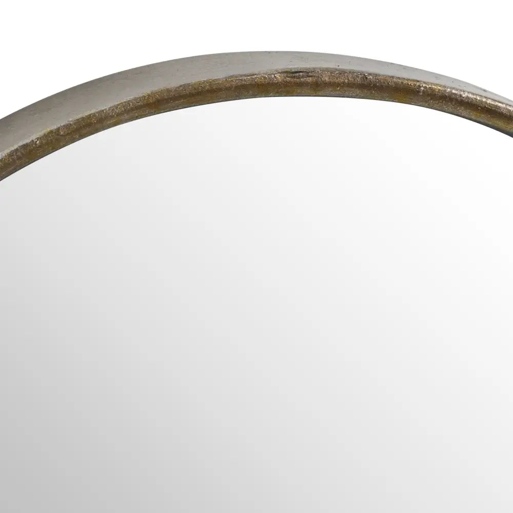 Curved edge of a stylish bronze finish wall mirror with a thin gold-toned frame