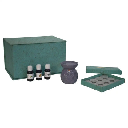 Green metal storage box with hinged lid for Taya Lilac Oil and two wax melts