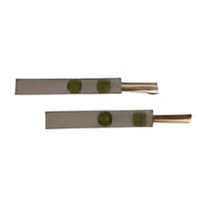 Metal tweezers with green rubber grips for adjusting apple cinnamon reed sticks in diffuser