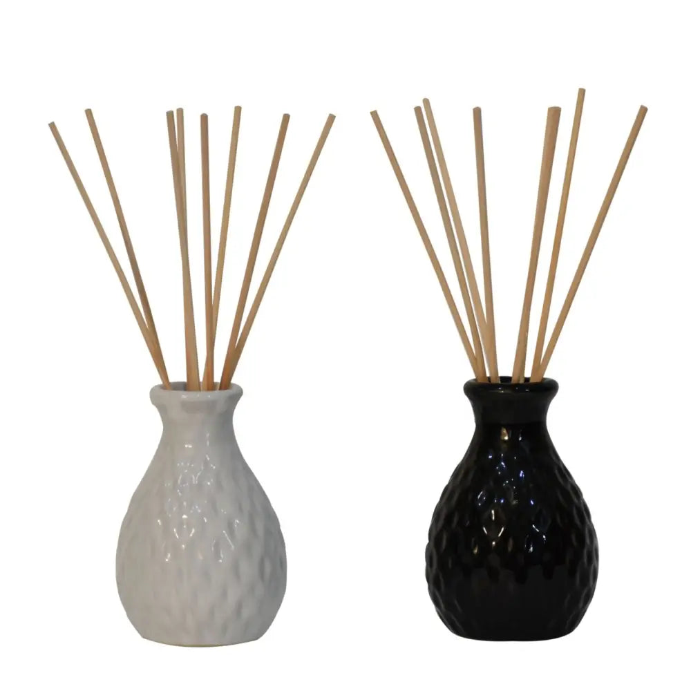 Two ceramic Mono Reed Diffuser vases, white and black, for cozy home fragrance